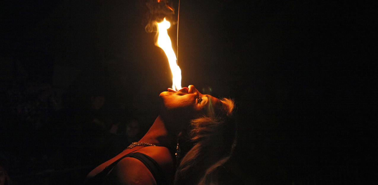 In this July 7, 2013 photo, drag queen Susan Brown spits fire during her performance in the "Fama" circus show in Santiago, Chile.  The only classic circus act in Fama is Brown's fire eating performance.  Fama has toured the country for more than a decade performing in modest tents and they say their show remains a refuge from discrimination. Chile has traditionally been a tough place for homosexuals. (AP Photo/Luis Hidalgo)